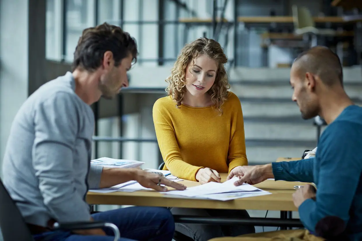 A group of people sitting around a table.