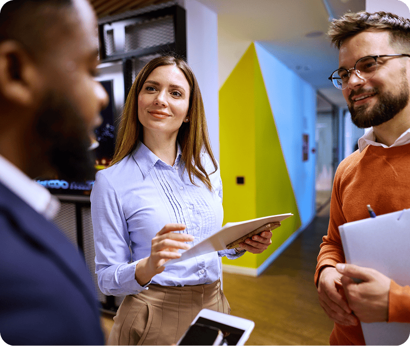 Colleagues chatting in colorful office environment