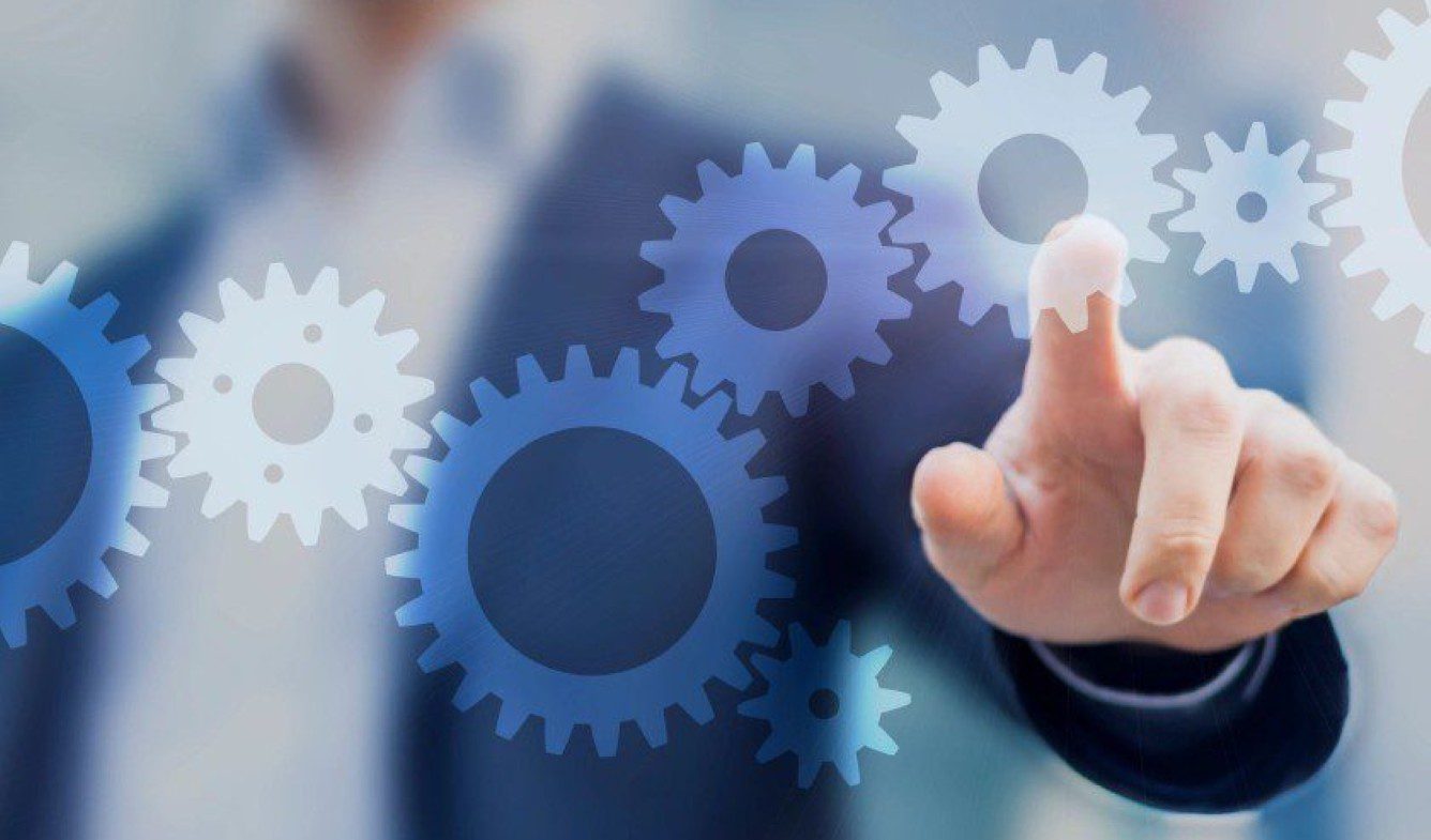 Businessman interacting with digital gears