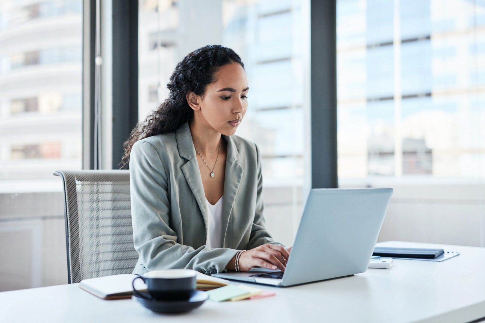 Shot of a young businesswoman working on a laptop in an office
