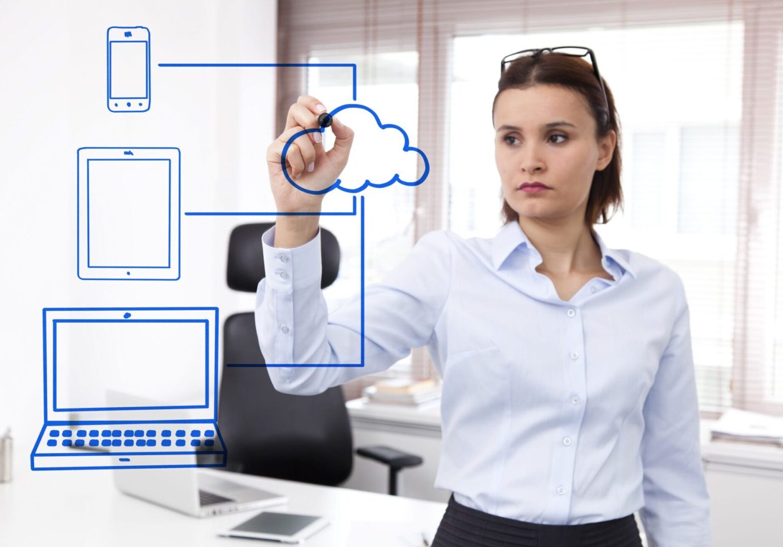 A woman drawing on a whiteboard with a cloud above her head.